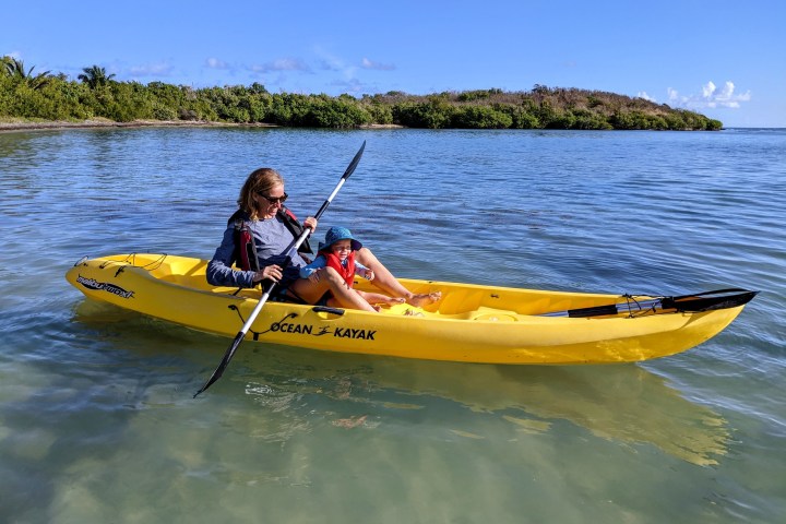 a man riding on the back of a boat in a body of water