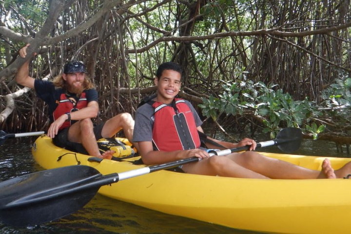 a group of people riding on the back of a boat